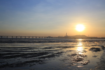 Fototapeta premium sunset of tidal beach and sunlit of chinese boat Ha Pak Nai at Yuen Long