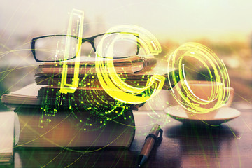 Crypto theme hologram with glasses on the table background. Concept of blockchain. Double exposure.
