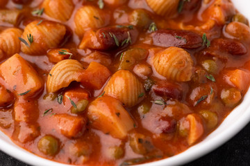 Vegetable grains peas soup in tomato sauce