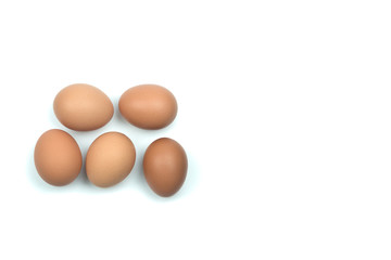Top view five brown eggs separated from the white background with space for writing.
