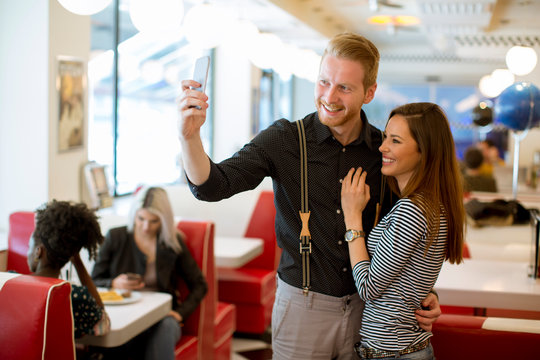 Young couple taking selfie in the diner