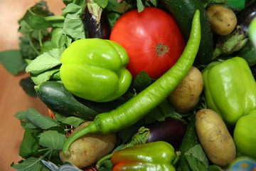 Assortment of fresh vegetables from Farmers market. Healthy food. Assorted fresh vegetables. On a black wooden background. View from above. Pepper, eggplant, cucumber .