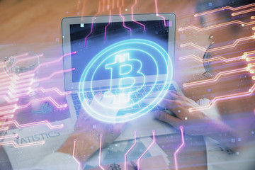 Blockchain theme hologram with man working on computer on background. Concept of crypto chain....
