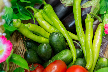 Assortment of fresh vegetables from Farmers market. Healthy food. Assorted fresh vegetables. On a black wooden background. View from above. Pepper, eggplant, cucumber .