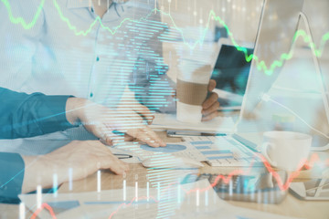 Multi exposure of chart with man typing on computer in office on background. Concept of hard work.