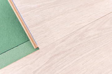 Installation laminate in the room, sheets environmentally friendly underfloor and laminate or parquet