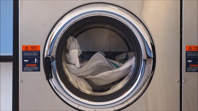public laundry with clothes inside washing machine