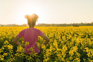 Mixed Race African American Girl Teenager Standing In Yellow Flowers