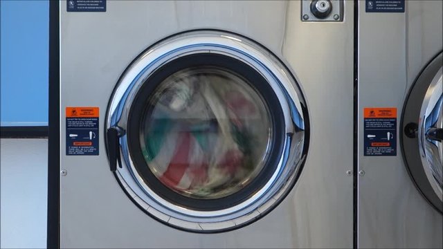 public laundry with clothes inside washing machine