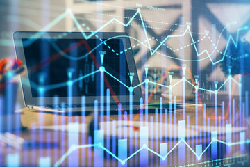 Forex market graph hologram and personal computer on background. Multi exposure. Concept of investment.