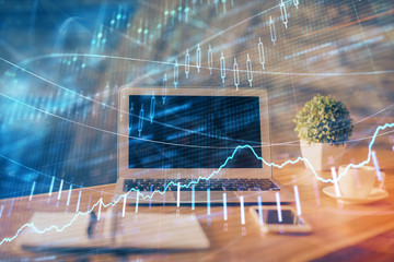 Double exposure of chart and financial info and work space with computer background. Concept of...