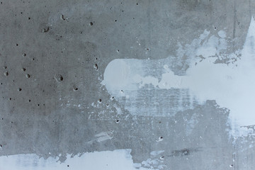 Puttying the wall with white putty, concrete wall with smeared irregularities, apartment repair