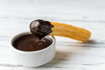 Churros with chocolate, a traditional Spanish sweet food pastry dessert, on white background