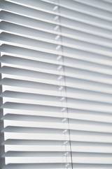 Closeup view of window with horizontal blinds