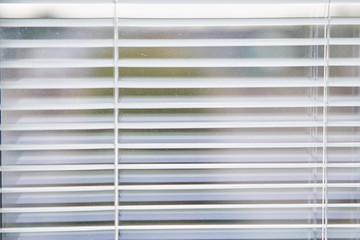 Closeup view of window with horizontal blinds