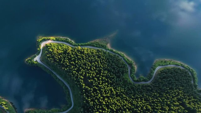 evening lake aerial panorama with the beautiful reflections and pine forest coastline