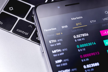 Notebook and smartphone with cryptocurrency stock market 