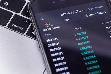 Notebook and smartphone with stock market