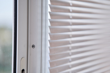 Closeup view of window with horizontal blinds