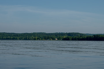 With the camsite in the distance the lake at Eucha Oklahoma is calm and inviting. Bokeh.