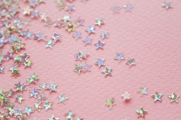 Golden stars glitter on pink background. Flat lay