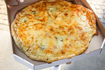 pizza in box (fast food, cheese, tomato sauce and other ingredients) concept, street food. food background. copy space