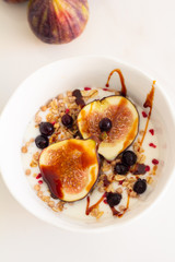 cereal with fig yogurt and berries on a white background