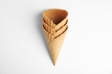 Empty wafer ice cream cones on white background, top view