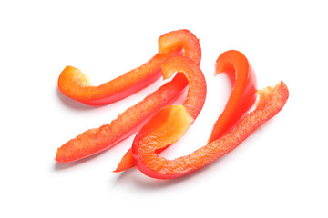 Slices of ripe red bell pepper on white background