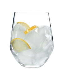 Glass with ice cubes and lemon slices for refreshing drink on white background