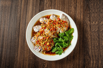 Chinese cuisine chili steamed red squid on wooden board background