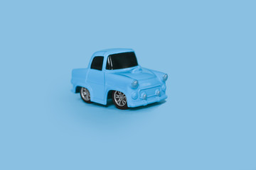 blue retro toy car on an isolated blue background