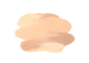 Samples of different foundation shades on white background, top view