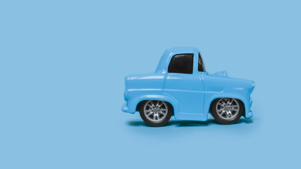 blue retro toy car on an isolated blue background