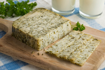  Piece of mature Dutch goats cheese with herbs