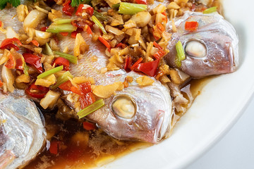 Chinese dish of hot chilli steamed red squid on white background