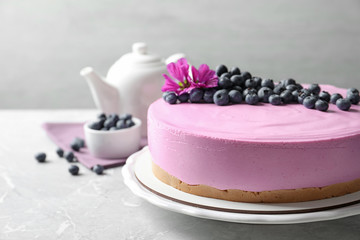 Obraz na płótnie Canvas Plate with tasty blueberry cake on light grey table. Space for text