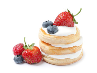 Fresh delicious puff pastry with sweet berries on white background