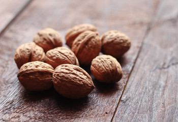 Walnuts isolated on the old wooden background in backlight