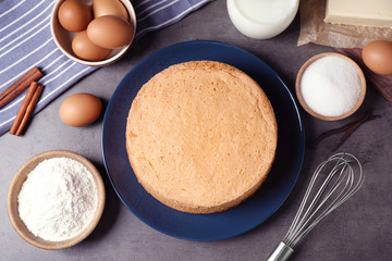 Flat lay composition with delicious fresh homemade cake on grey marble table
