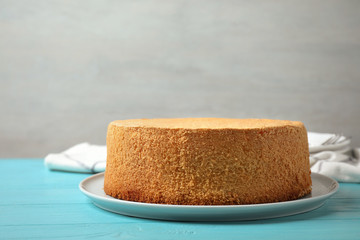 Delicious fresh homemade cake on light blue wooden table