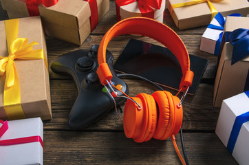 Orange headphones music audio, gamepad, smartphone, mobile phone, box with ribbon bow gift on...