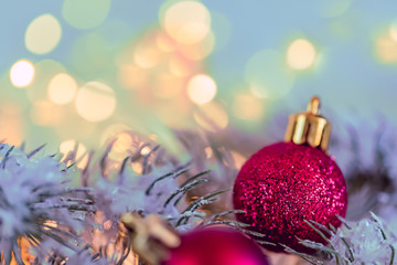 Christmas and New Year Holiday greeting card. Beautiful red balls, pine branches and a garland in the snow.