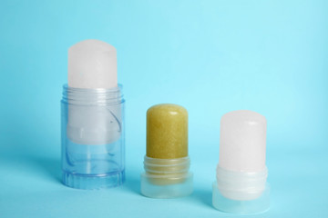 Natural crystal alum stick deodorants on light blue background