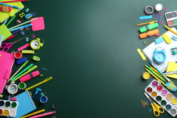 Different bright school stationery on green background, flat lay. Space for text
