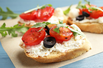 Delicious tomato bruschettas on table, closeup. Traditional Italian antipasto