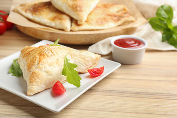 Fresh delicious puff pastry served on wooden table