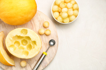 Flat lay composition with melon balls on light background, space for text