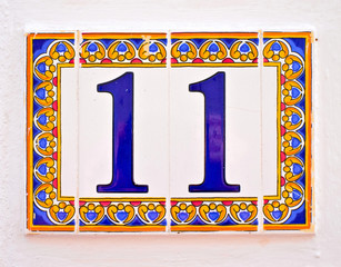 Number 11 / eleven, ornamental tiles on white background.