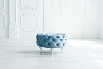 round blue stool in white studio..